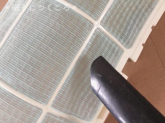 エアコンフィルターのホコリを掃除機で吸う